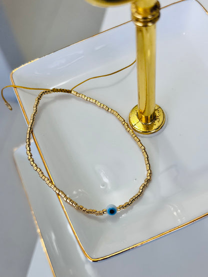 Ojo en hilo Dorado